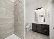Thumbnail 8 of 42 - A bathroom with a toilet, sink, and a shower.