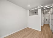 Thumbnail 25 of 42 - A room with wooden floors and white walls.