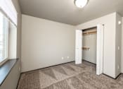 Thumbnail 25 of 81 - an empty room with a closet and a window