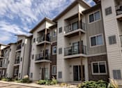 Thumbnail 3 of 81 - A row of modern apartment buildings with balconies and windows.