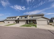 Thumbnail 56 of 81 - A large house with a garage is situated in a residential area.