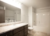 Thumbnail 9 of 21 - A bathroom with a sink, toilet, and bathtub.
