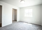 Thumbnail 17 of 21 - A room with a carpeted floor and a window.
