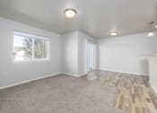 Thumbnail 10 of 22 - A room with a carpeted floor and a window.