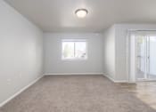 Thumbnail 5 of 22 - A room with a carpeted floor and a window.