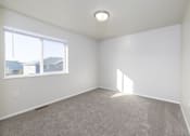 Thumbnail 13 of 22 - A room with a carpeted floor and a window.