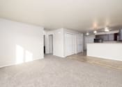 Thumbnail 19 of 22 - A spacious room with white walls and wooden flooring.