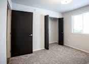 Thumbnail 13 of 21 - Spacious bedroom with neutral walls and ample natural light.