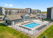 Thumbnail 26 of 35 - an aerial view of a swimming pool in front of an apartment building