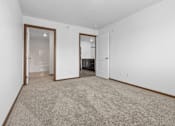 Thumbnail 29 of 38 - A room with a carpeted floor and two open doors.
