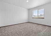 Thumbnail 28 of 38 - A room with a carpeted floor and a window.