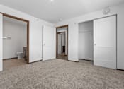 Thumbnail 26 of 38 - A spacious room with carpeted floor and white walls.