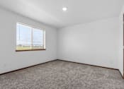 Thumbnail 38 of 38 - A room with a carpeted floor and a window.
