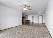 Thumbnail 37 of 38 - A room with a ceiling fan and a carpeted floor.