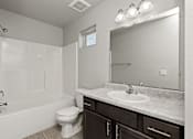 Thumbnail 11 of 37 - A white bathroom with a toilet, sink, and shower.