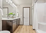 Thumbnail 33 of 43 - A white bathroom with a white tub and a white toilet.