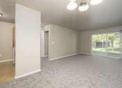 Thumbnail 10 of 41 - A spacious room with a carpeted floor and a ceiling light.
