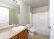 Thumbnail 23 of 41 - A white toilet sits next to a sink in a bathroom.