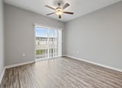 Thumbnail 14 of 29 - an empty living room with a ceiling fan and a window