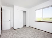 Thumbnail 20 of 54 - an empty room with two doors and a window
