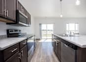 Thumbnail 27 of 54 - a large kitchen with stainless steel appliances and marble counter tops
