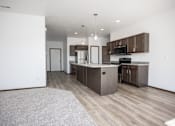 Thumbnail 29 of 54 - an open kitchen and living room with wood flooring and