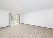 Thumbnail 5 of 35 - A room with a carpeted floor and a sliding glass door.