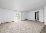 Thumbnail 22 of 35 - A spacious room with carpeted floor and sliding glass doors.