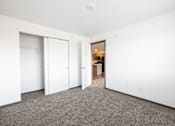 Thumbnail 16 of 58 - A white room with a carpeted floor and a white door.