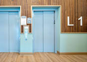 Thumbnail 8 of 50 - Two doors with a sign on the wall above them.