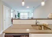 Thumbnail 34 of 50 - A kitchen with a sink and a window.
