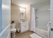 Thumbnail 42 of 50 - A white bathroom with a toilet, sink, and shower.