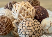 Thumbnail 50 of 50 - A collection of decorative balls with different patterns and textures are displayed on a white plate.
