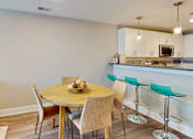 Thumbnail 47 of 50 - A dining area with a table and chairs.