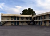 Thumbnail 8 of 8 - a motel building with a car parked in front of it