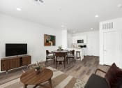 Thumbnail 1 of 17 - a living room and dining room with a table and chairs