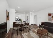 Thumbnail 2 of 17 - a living room and dining room with a table and chairs