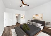 Thumbnail 7 of 17 - a bedroom with a large bed and a ceiling fan