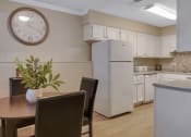 Thumbnail 9 of 19 - a kitchen and dining room with a large clock on the wall