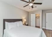 Thumbnail 13 of 19 - a bedroom with a large bed and a ceiling fan