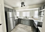 Thumbnail 3 of 11 - a kitchen with stainless steel appliances and gray cabinets