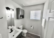 Thumbnail 4 of 11 - a bathroom with a toilet and a sink
