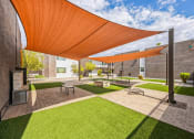 Thumbnail 14 of 23 - a courtyard with awnings and benches and grass