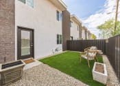 Thumbnail 10 of 23 - a yard with a table and chairs in front of a building
