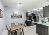 Thumbnail 2 of 23 - an open kitchen and dining room with a table and chairs