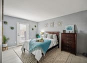Thumbnail 8 of 23 - a bedroom with a bed and a dresser