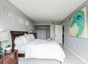 Thumbnail 9 of 23 - a bedroom with a large bed and a painting on the wall