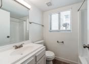 Thumbnail 9 of 22 - a bathroom with a sink toilet and a mirror