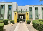 Thumbnail 22 of 22 - a building with two yellow pillars and a green facade
