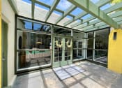 Thumbnail 16 of 22 - a large glass door entrance with wreaths hanging from the ceiling